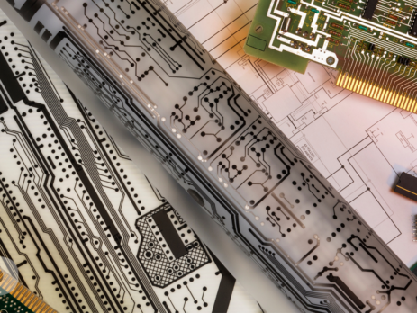 Cad drawings with printed circuit boards on a table.