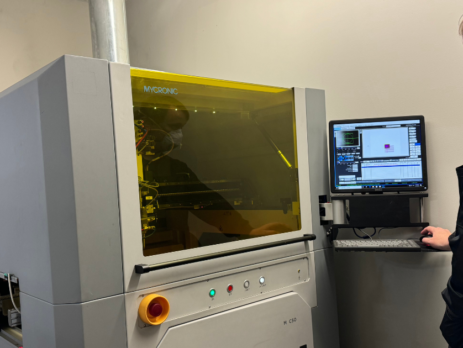 Operator standing next to a conformal coating machine