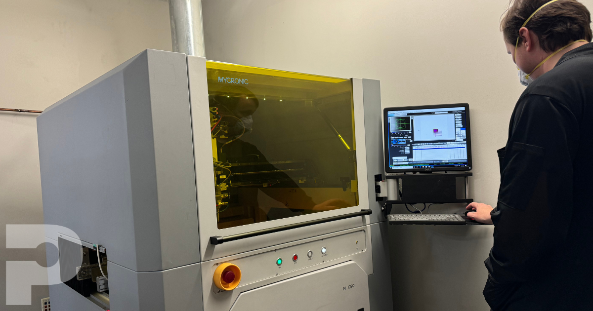 Operator standing next to a conformal coating machine