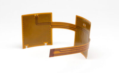 Two square pieces of Flex Circuitry connected by a thin strip of flex in C shape.