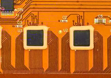 Image of flex pcb with a epoxy around the chip solder joints