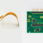 Flexible printed circuit and green rigid PCB displayed side by side, showcasing PICA’s flex and rigid circuit manufacturing capabilities.