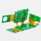 Rigid-flex PCB assembly featuring green circuit boards connected by flexible copper interconnects.