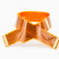 Flexible printed circuit made with orange polyimide film, showing copper traces and connectors in a curved configuration.