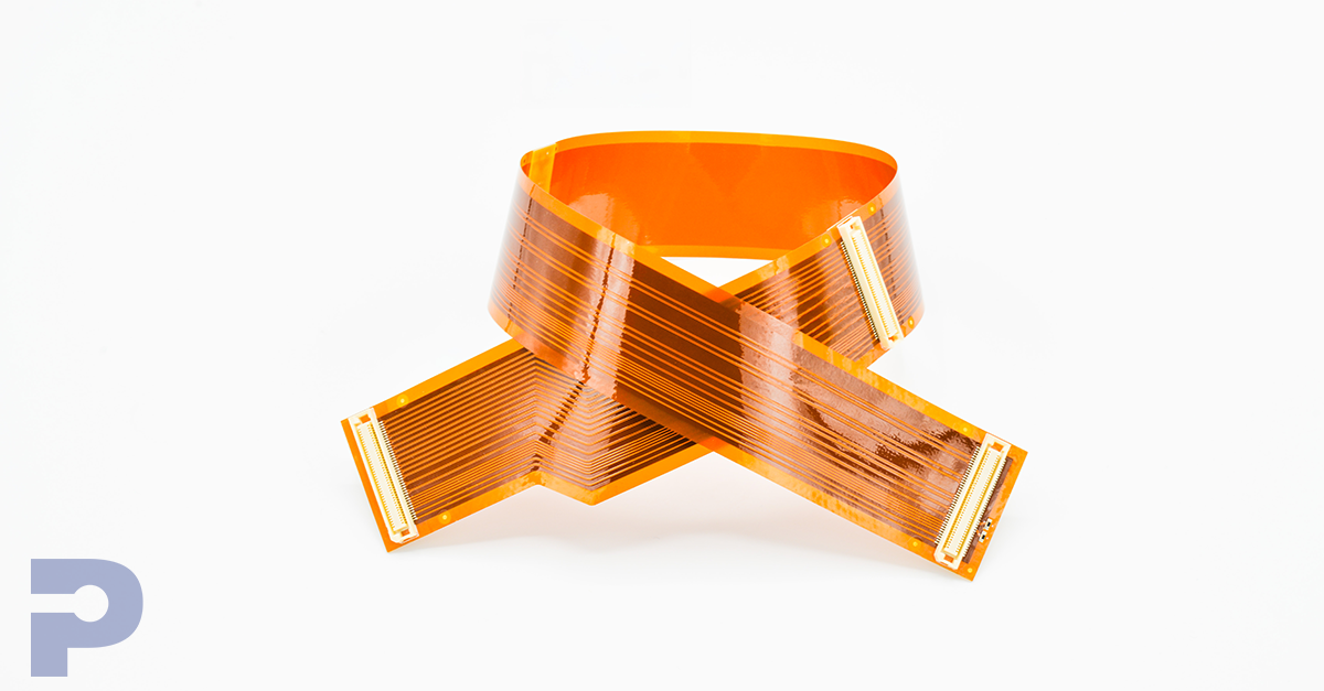 Flexible printed circuit made with orange polyimide film, showing copper traces and connectors in a curved configuration.